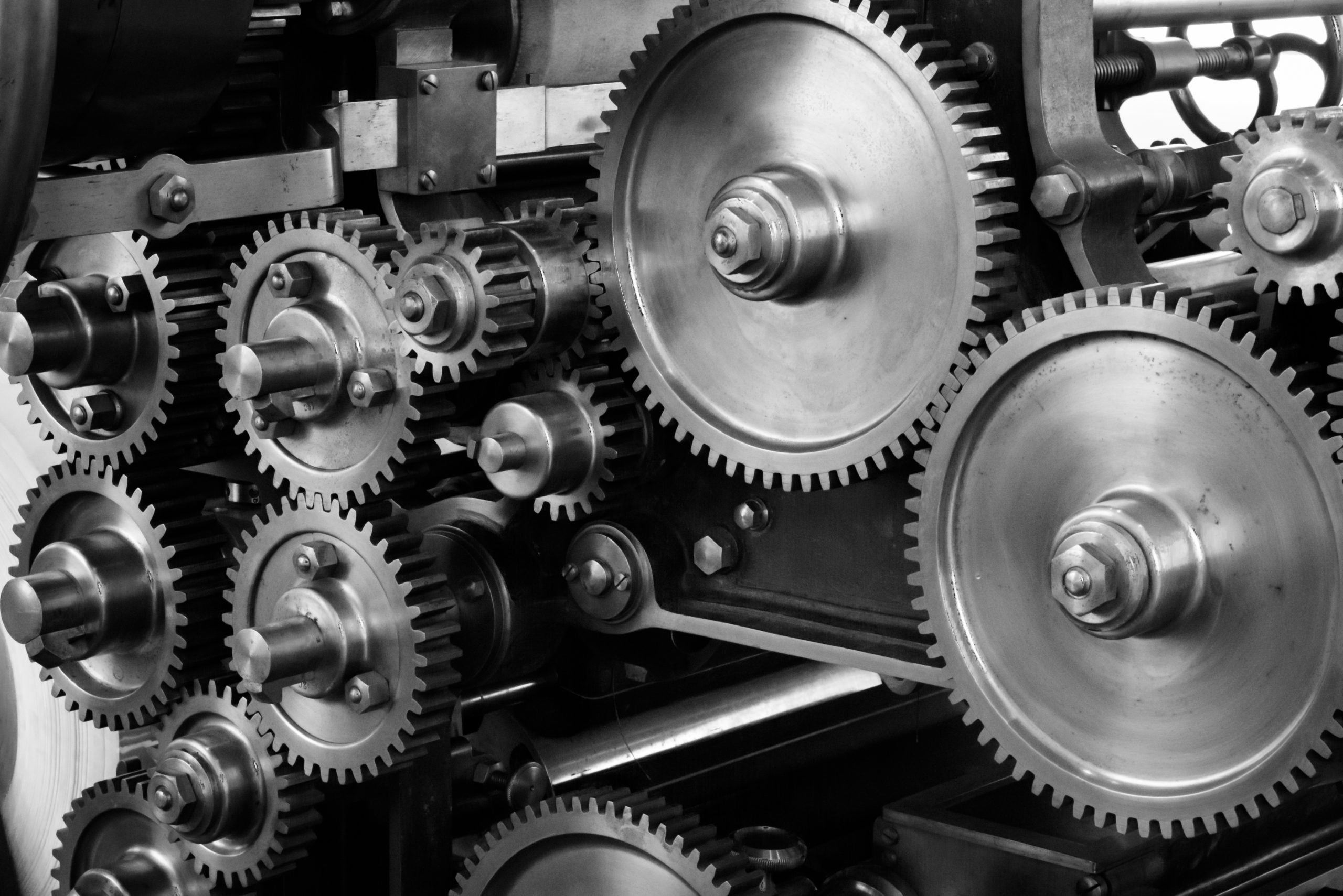 A picture showing several gears connected by machinery much like the way networks tools, be it hardware or software, a feature or process component, can be optimized using configuration management (CM).