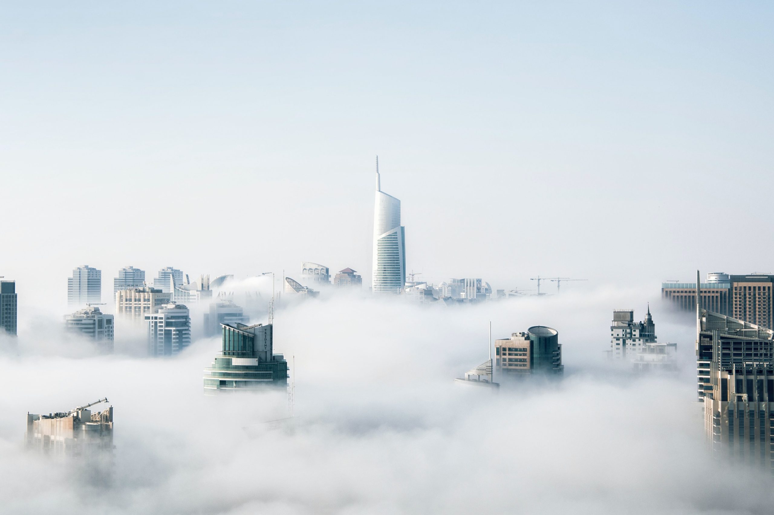 A picture of city covered by clouds not unlike a network which must protect itself from malicious weather. In this article we look at the difference between DMZ networks and zero trust networks, how they relate, and whether DMZ networks are enough to meet modern network threats.
