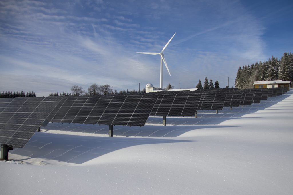 Solar panels and a windmill power a grid offering end-user power for an edge location.