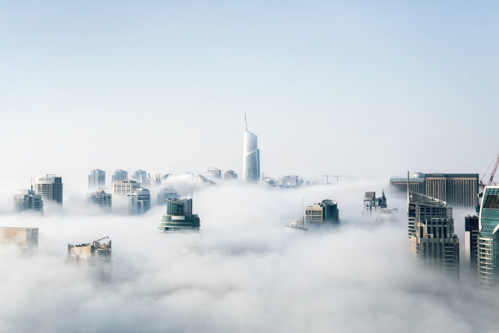 A picture of a city with clouds covering the street floor as this article is about the best cloud and online backup solutions.